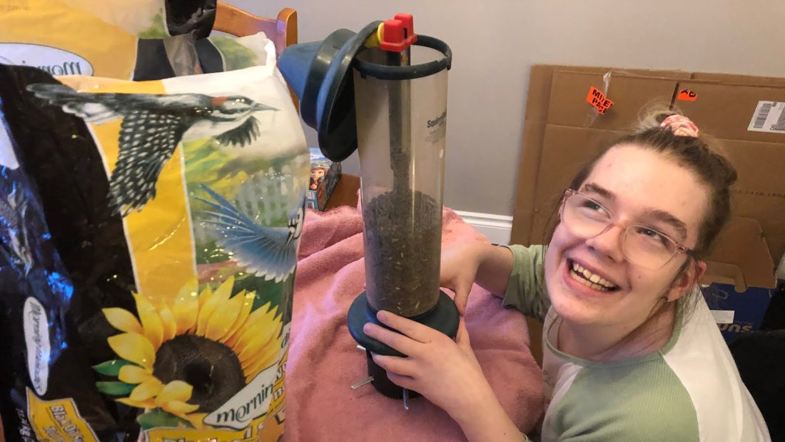 Me helping my dad fill up the birdfeeder